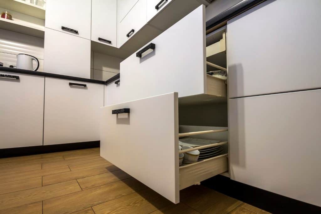 Open drawers in minimalist kitchen.